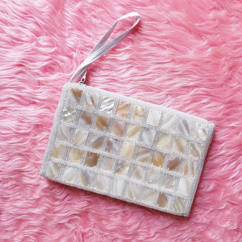 Small white beaded bag by the brand shira leah